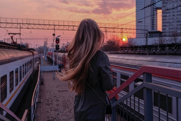 beautiful woman spending time in a railroad station